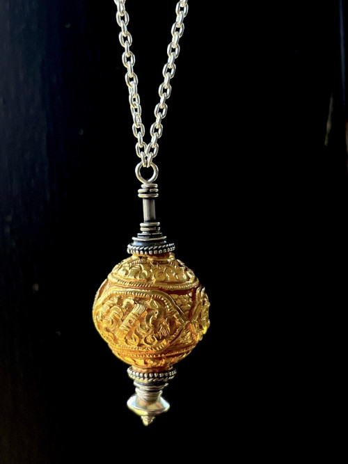 Tibetan drop with sacred symbols